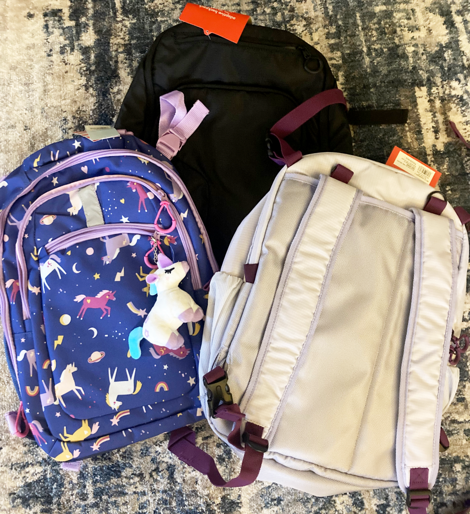 Three different colored adaptive backpacks.